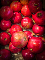 Vivid colors of autumn in food produce - pomegranates.