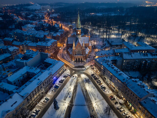 St Joseph church on snowy Rynek Podgorski square, Krakow, Poland, aerial view in the winter night