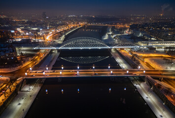 Aerial view of bridges over Vistula river in Krakow, Poland, illuminated in the winter evening