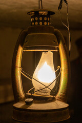 Kerosene lamp burn. Old metal lantern with a glass bulb in the basement