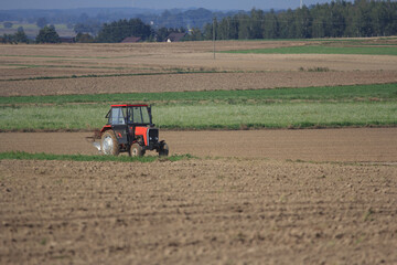 Agriculture machinery in action a tractor plows a field on a bright day © Bagatela
