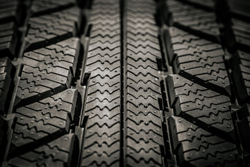 Close-up of a winter tire tread pattern, showcasing the intricate grooves and zigzag details...