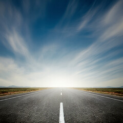 Fototapeta premium a straight road stretching into the horizon across a deserted land cloudy weather