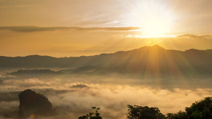 Sunset mountain range beautiful landscape mist foggy sunrise beam. Golden sky Mountain landscape foggy windy mountain. Amazing Landscape cloud sky on sunrise. Countryside gold sunlight heaven scene