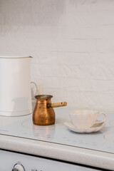 An Elegant Coffee Setup That Features a Beautiful Copper Pot Alongside a Delicate Teacup