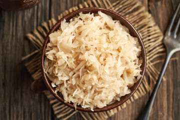 Homemade fermented cabbage or sauerkraut in a pot on a table