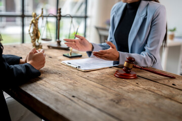 Lawyer explaining contract and using hand gestures to client during consultation