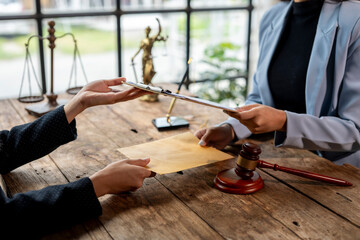 Lawyers exchanging legal documents during a meeting