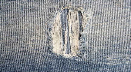 Ripped jeans background blue denim pattern. Jeans texture for backdrop pattern. Jeans texture pattern. Fabric pattern background.
