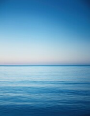 Obraz premium Blue ocean with a small boat in the distance