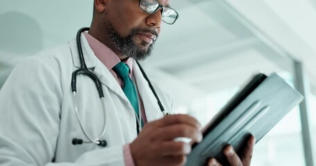 Tablet, black man and surgeon in hospital with research for medical diagnosis with telehealth. Digital technology, communication and African male doctor with email for treatment approval in clinic.