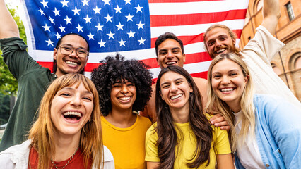 Multiracial American people holding United States flag - Diverse citizen celebrating USA National...