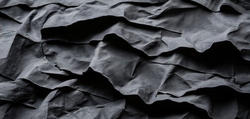 Obraz premium Black satin cloth with soft folds and highlights, luxurious texture, moody elegance in textile design