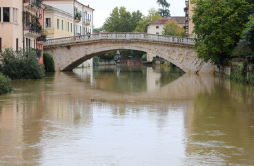 Fototapeta premium bridge named SAN MICHELE BRIDGE in the city of VICENZA in Italy and the muddy RETRONE river during the flood