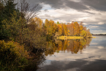 An overcast, still, autumnal HDR image of Loch Ashie on Drumashie moor in the Great Glen, Inverness-shire, Scotland