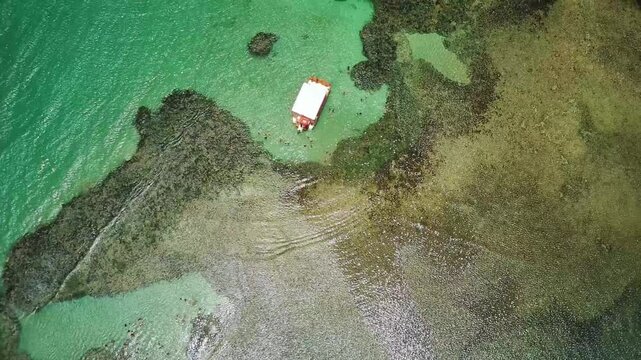 Catamaran sailing through the coral reefs in the natural pools of Joao Pessoa in Paraiba, Brazil.