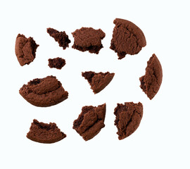 Broken chocolate cookies isolated on white background, top view.
