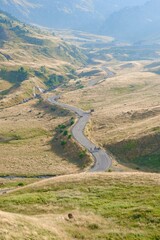 Aerial view on mountain road between dry hills in Pyrenees, France. Vertical photo
