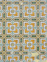 Vintage scratched ceramic tiles of yellow and green colour. Vertical photo