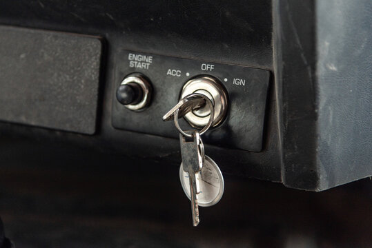 Vehicle Ignition with Key Inserted, Close-Up of Truck Ignition Switch Panel in Off Position, Featuring Start Engine Button and Keychain. Automotive Security, Transportation, and Car Starting Concept