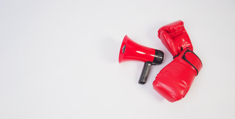 megaphone and boxing gloves on white background