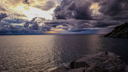 Evening view of the sea, lake or ocean and sky with dark dramatic clouds. Mediterranean vacation in September.