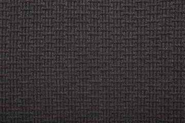 Dark black soft knitted fabric background. Empty place for text. Closeup. Top down view.