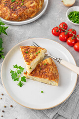 Spanish omelette tortilla with potatoes and onion on a stone background. Spanish cuisine. Top view.