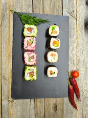 Delicious sushi rolls on a granite chopping board.  View from above.