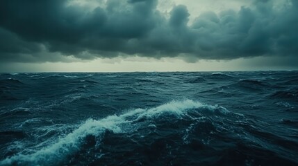Obraz premium Dramatic, stormy seascape with dark, heavy clouds and choppy waves.