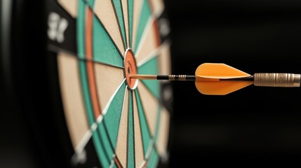 Close-up view of a dart hitting the bullseye on a dartboard with colorful segments and an orange dart flight.