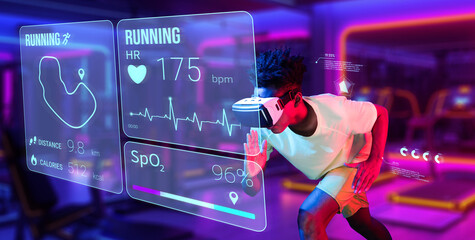 Happy african man wearing VR glasses and shirt while exercising at gym with vibrant color. Male model posing running posture while using artificial intelligence training and doing fitness. Ingenuity.