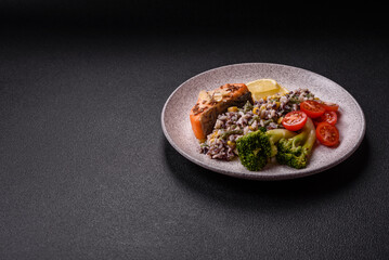 Grilled salmon with salt and spices, broccoli, tomatoes, rice