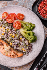 Grilled salmon with salt and spices, broccoli, tomatoes, rice
