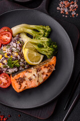 Grilled salmon with salt and spices, broccoli, tomatoes, rice