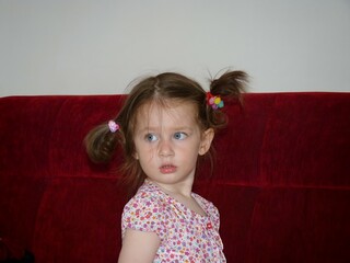 A Curious Glance: Innocence and Wonder Reflected in a Young Girl’s Expressions, Capturing a Moment of Childhood Curiosity and Timeless Innocence