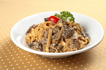 fettuccine with dried mushroom sauce on plate