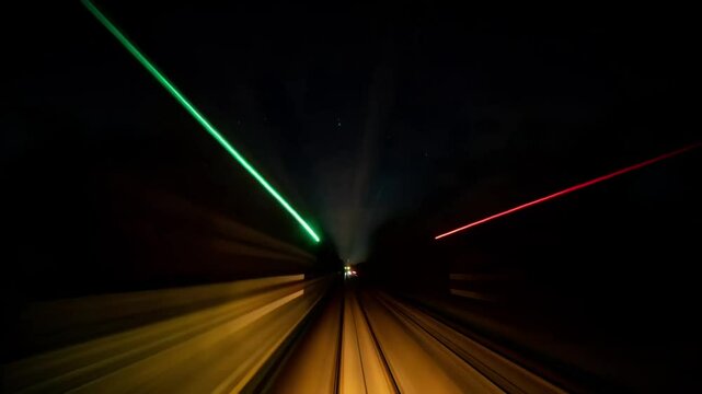 Nighttime time-lapse POV of a train speeding through Berlin, landscape, fast flashing lights motion, frontal driver view