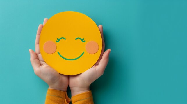 World Mental Health day banner. Concept of self care, happiness, harmony, creative mind. Hands holding yellow happy smile face on blue background. Copy space