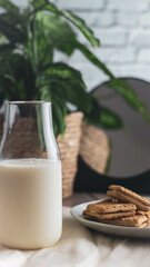 cookies and milk, mirror reflection, plant in the background. 
