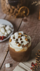 hot chocolate with marshmallow  and chocolate pieces photo taken from above, cosy vibe. 