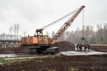 Peat mining bog, Peat mining machinery. in rain.