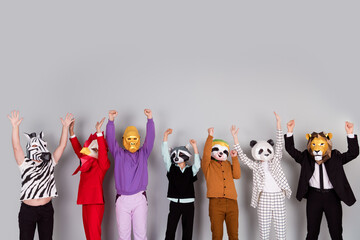 Full size photo of zebra gorilla raccoon lion panda sloth rooster mask people raise fists empty...