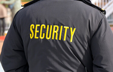 Embroidered word Security on the back of a uniform jacket