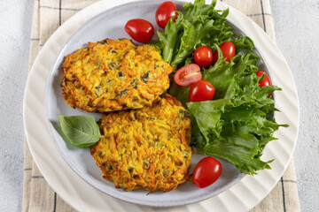 pumpkin carrot potato patties on plate, top view