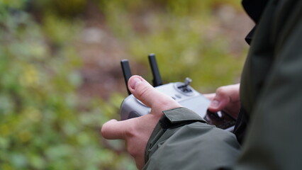 A man holds a drone remote control in his hands