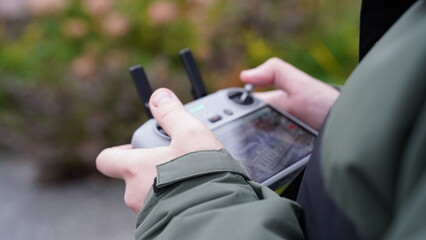 A man holds a drone remote control in his hands