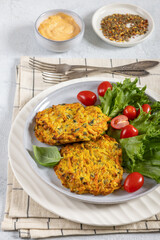 pumpkin carrot potato patties on plate, top view