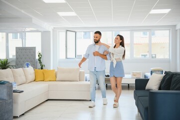 Fototapeta premium Woman with her husband at the furniture store showroom