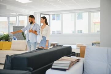 Married couple in the shop choosing furniture